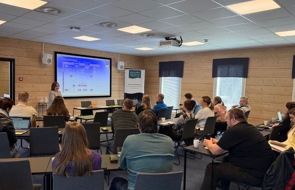 Työpajan osallistujia seuraamassa koulutusta.